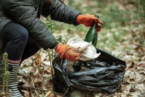 Volunteer collecting trash in nature. yard waste