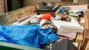 Overflowing dumpster filled with debris. hauling services